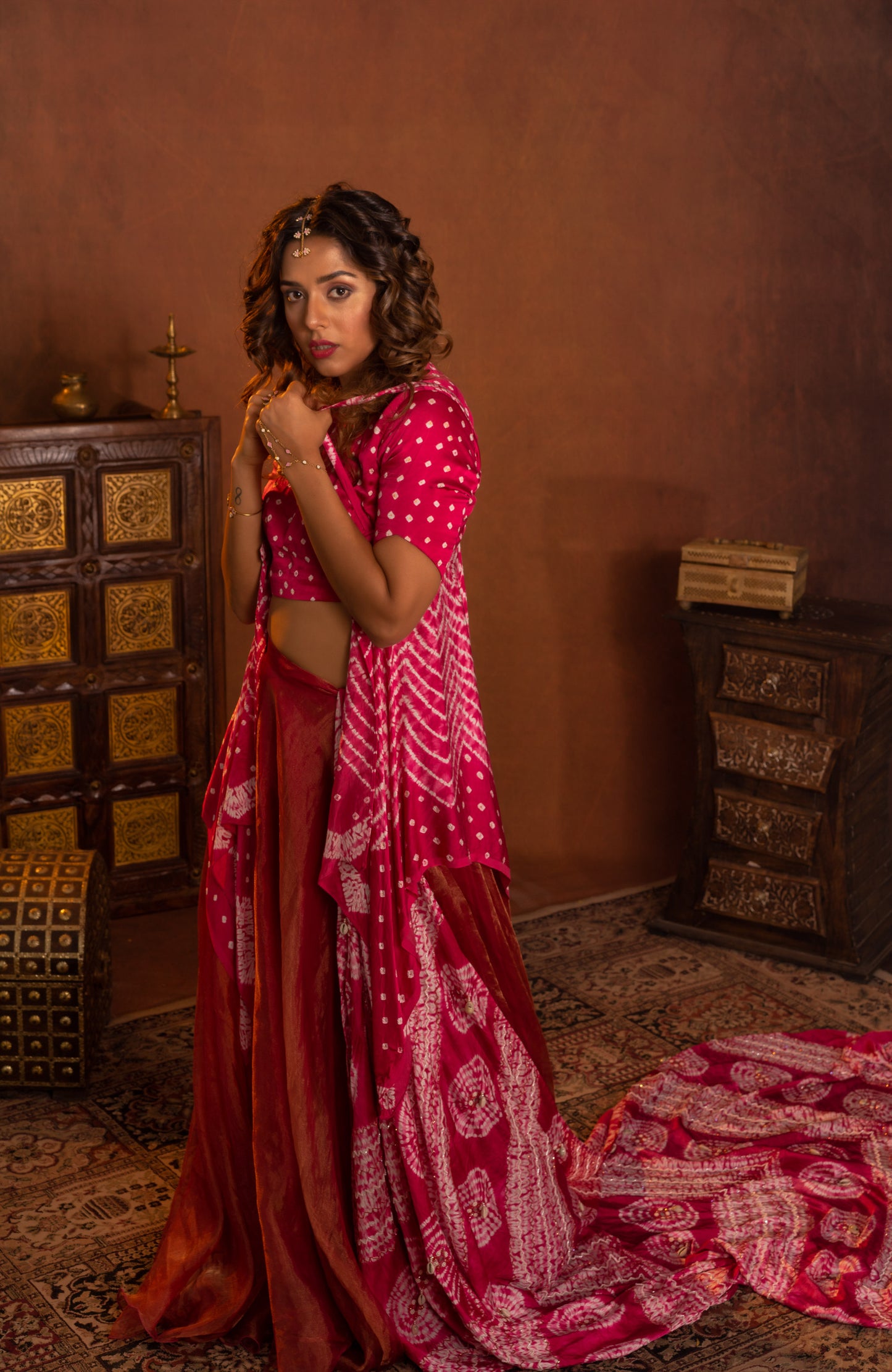 Shibori blouse styled with organza tissue bias skirt and embroidered dupatta. Additional Suspender peplum can be styled inside or outside the blouse