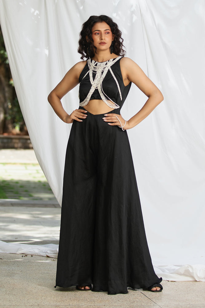 
                  
                    Cutout jumpsuit with a play of pearl strands
                  
                