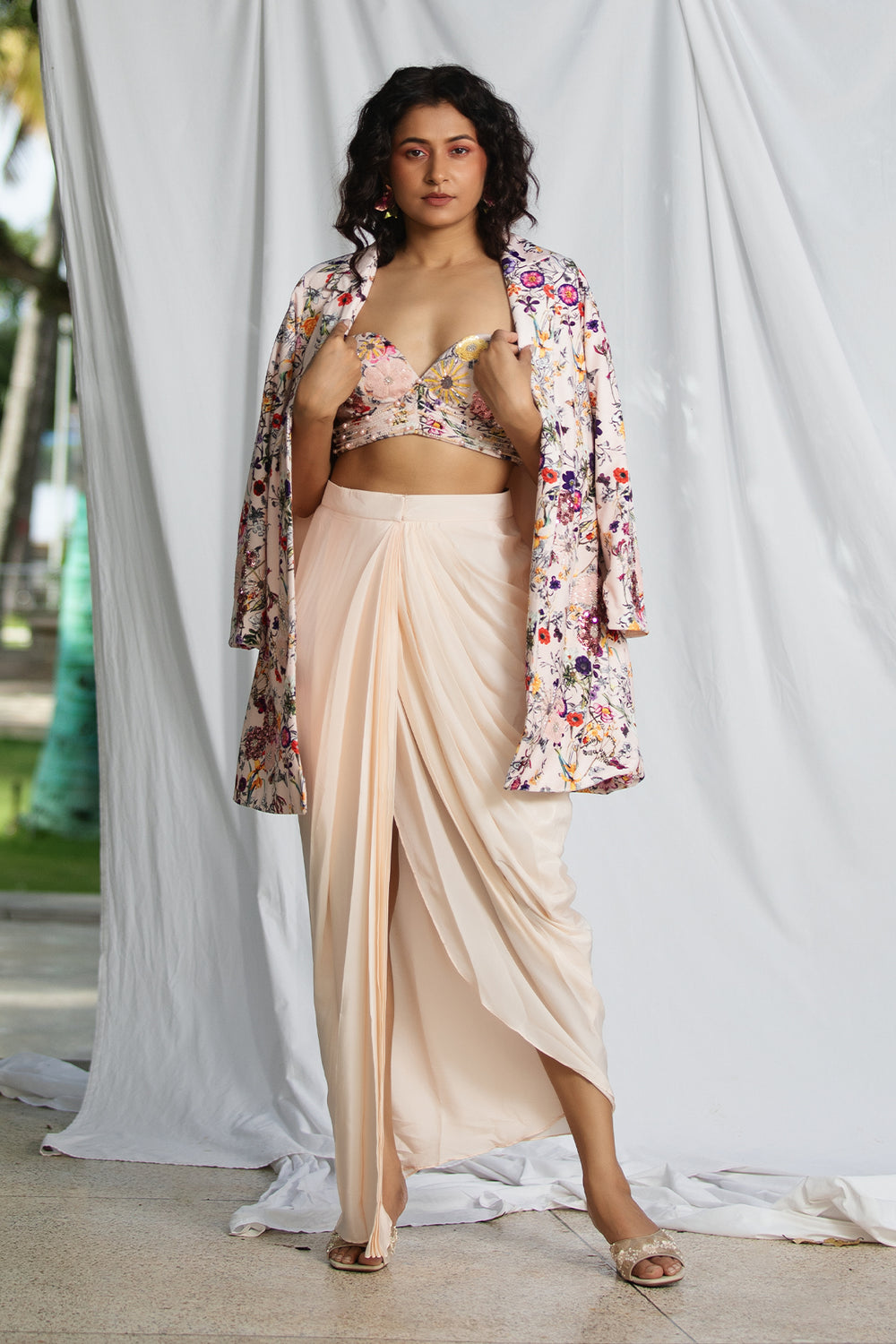 Suede blazer styled with embroidered bustier and draped skirt