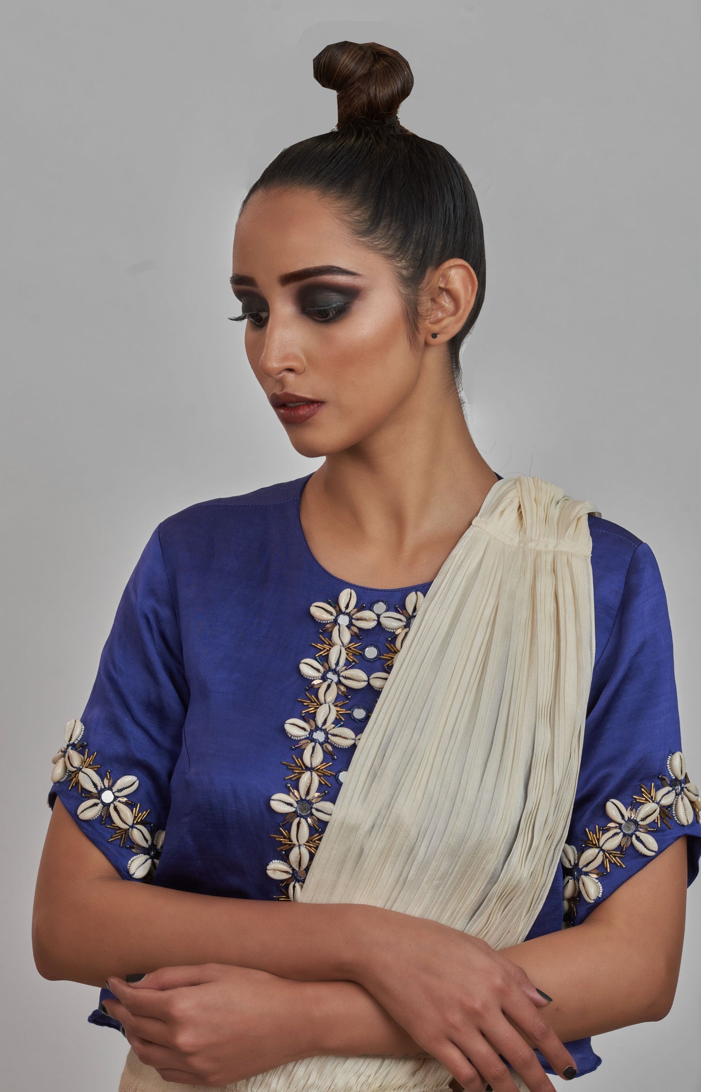 
                  
                    Kodi embroidered blouse with off white draped saree
                  
                