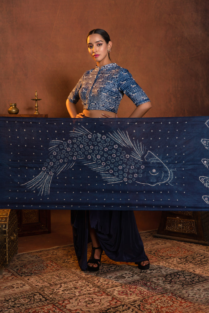 
                  
                    Dhoti draped skirt styled with shibori hand worked blouse and hand dyed fishes in bandhani dupatta
                  
                