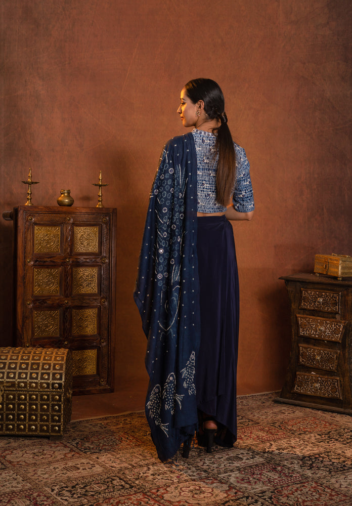 
                  
                    Dhoti draped skirt styled with shibori hand worked blouse and hand dyed fishes in bandhani dupatta
                  
                